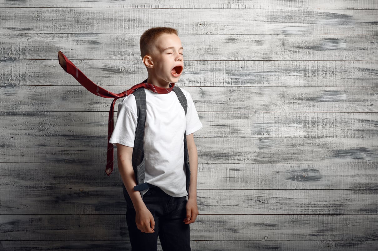 Little Boy against Airflow, Wooden Background